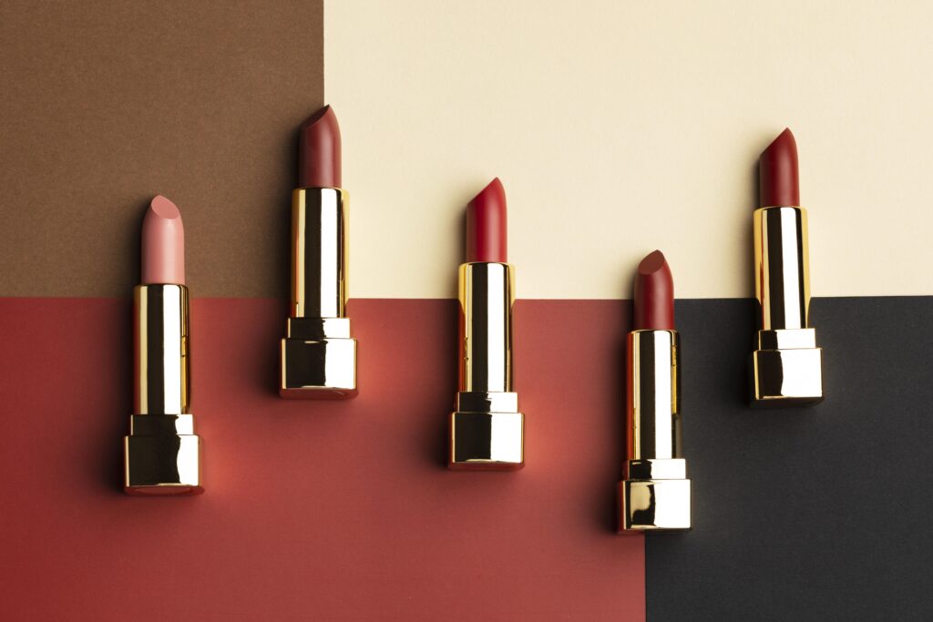 Flatlay of top 5 Sugar lipsticks in vibrant shades, perfect for bold, long-lasting color and essential additions to any makeup kit.